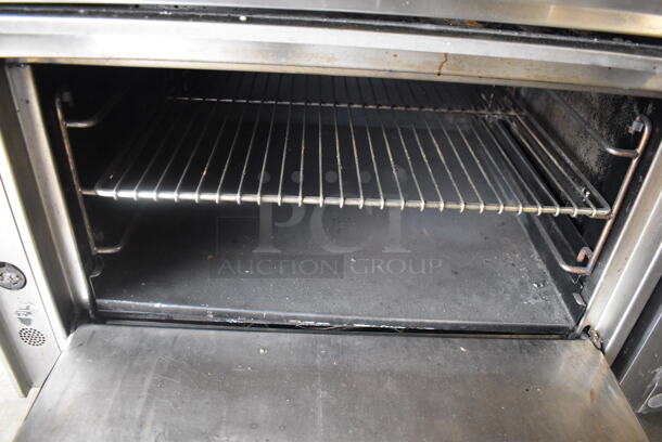 Jade Range Commercial Stainless Steel Natural Gas Powered Oven With 6 Gas Burners And Salamander Broiler and Salamander Shelves On Commercial Casters.  - Image 6 of 9