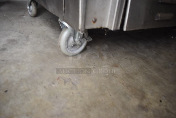 Jade Range Commercial Stainless Steel Natural Gas Powered Oven With 6 Gas Burners And Salamander Broiler and Salamander Shelves On Commercial Casters.  - Image 9 of 9