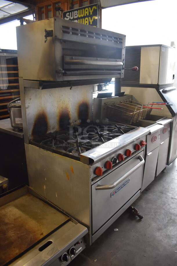 Bakers Pride Commercial Stainless Steel 6 Burner Natural Gas Powered Range With Standard Oven With  Steel Racks and Salamander Broiler On Commercial Casters.  - Image 2 of 8