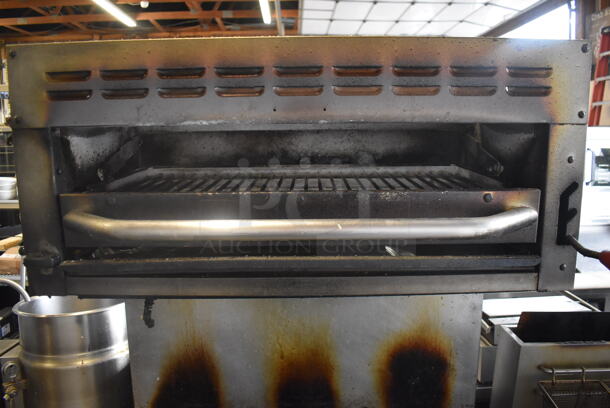 Bakers Pride Commercial Stainless Steel 6 Burner Natural Gas Powered Range With Standard Oven With  Steel Racks and Salamander Broiler On Commercial Casters.  - Image 4 of 8