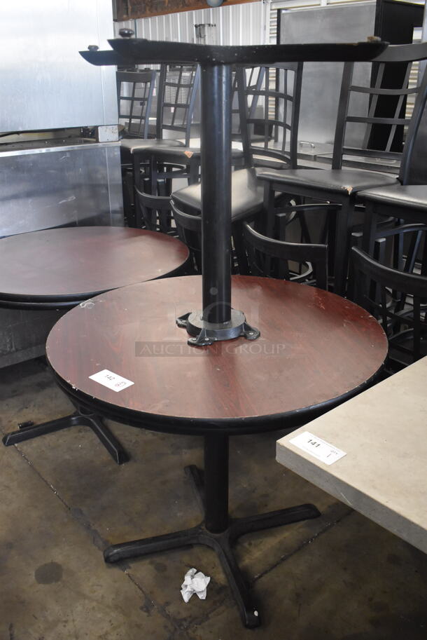 Circular Cafe Tables On 4 Prong Base. 1 Faux Wood Top and One Black Top. 2 Times Your Bid! 