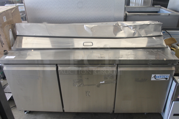 BRAND NEW SCRATCH AND DENT! Avantco 178APT71HC Commercial Stainless Steel 3-Door Refrigerated Sandwich/Salad Prep Table With Polycoated Shelves On Commercial Casters. 115V. Tested and Powers On But Does Not Get Cold - Image 1 of 12
