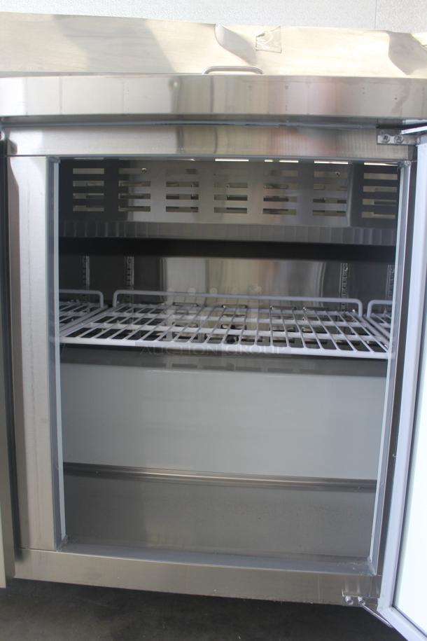 BRAND NEW SCRATCH AND DENT! Avantco 178APT71HC Commercial Stainless Steel 3-Door Refrigerated Sandwich/Salad Prep Table With Polycoated Shelves On Commercial Casters. 115V. Tested and Powers On But Does Not Get Cold - Image 8 of 12
