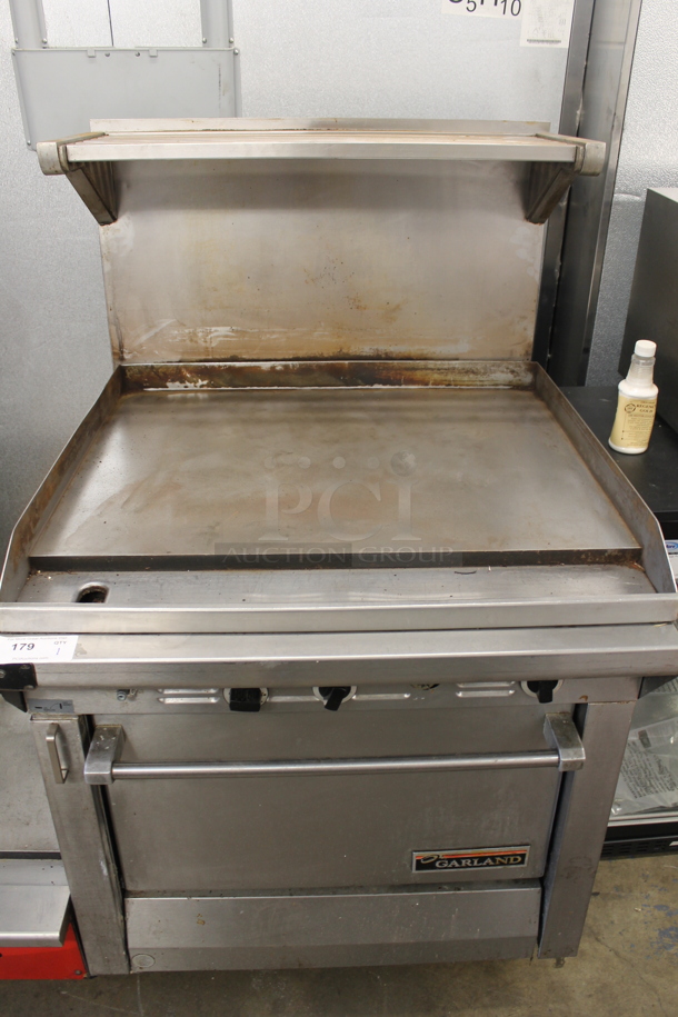 Garland M47R Commercial Stainless Steel Natural Gas Powered Griddle With Oven And Backsplash With Overshelf.  - Image 1 of 9