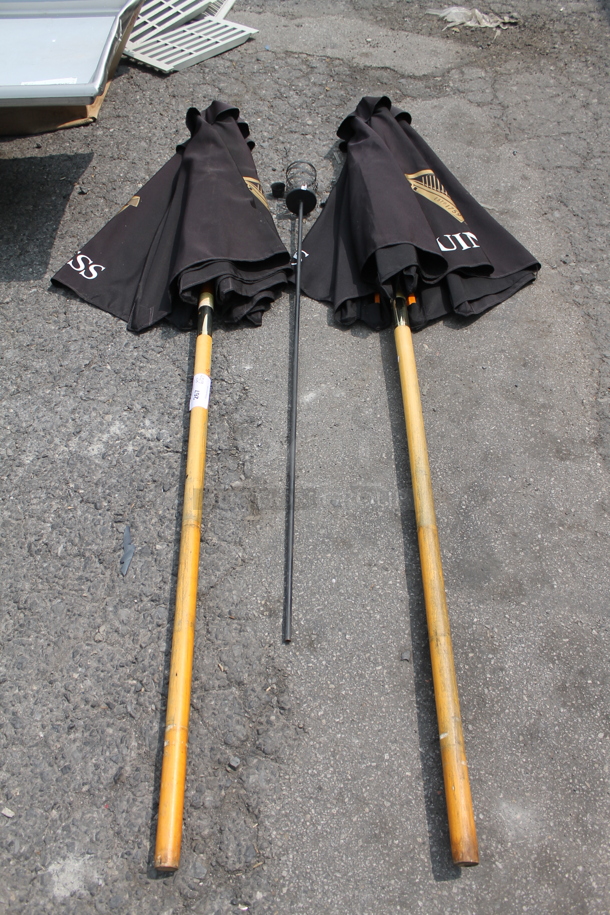ALL ONE MONEY! Lot of 2 Black Outdoor Table Umbrellas And Outdoor Torch - Image 1 of 3