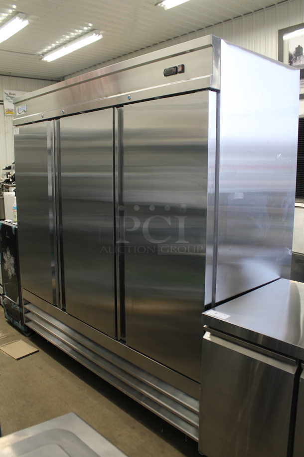 BRAND NEW SCRATCH AND DENT! 2023 Avantco 178SS3FHC Stainless Steel Commercial 3 Door Reach In Freezer w/ Poly Coated Racks on Commercial Casters. 115 Volts, 1 Phase.  Tested and Working! - Image 2 of 7