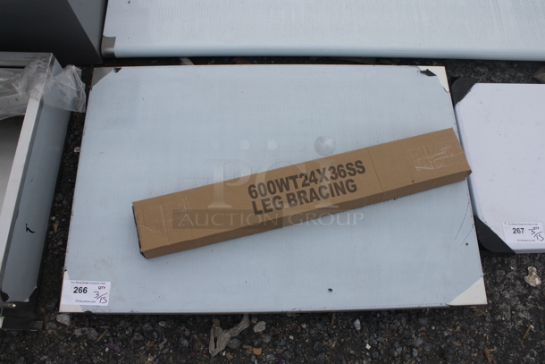 BRAND NEW SCRATCH AND DENT! Regency 600WT24X36SS 24" x 36" 16-Gauge 304 Stainless Steel Commercial Open Base Work Table - Image 3 of 5