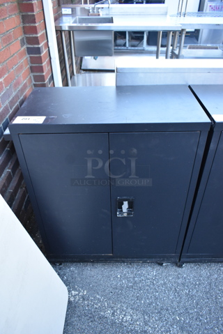 Black Metal 2 Door Cabinet w/ Contents on Commercial Casters. 