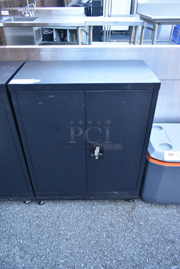 Black Metal 2 Door Cabinet w/ Contents on Commercial Casters.  - Image 1 of 4