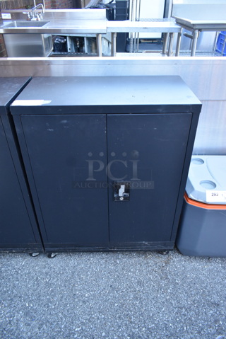 Black Metal 2 Door Cabinet w/ Contents on Commercial Casters. 