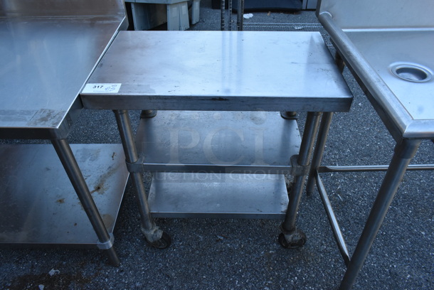 Stainless Steel Table w/ 2 Metal Under Shelves on Commercial Casters.  - Image 1 of 5