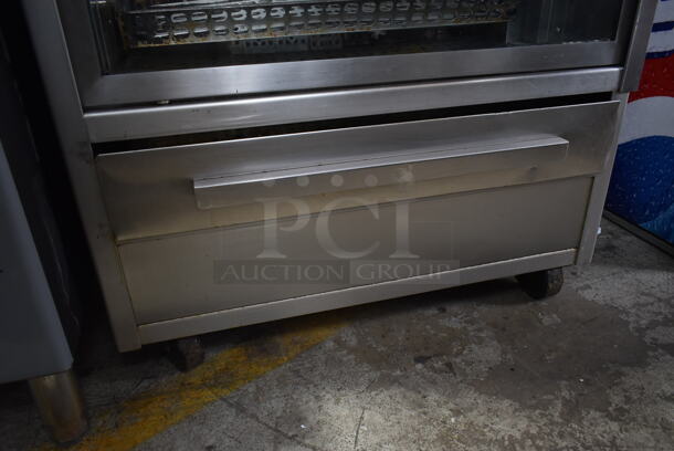 Stainless Steel Commercial Floor Style Natural Gas Powered 7 Spit Rotisserie Oven on Commercial Casters.  - Image 3 of 9