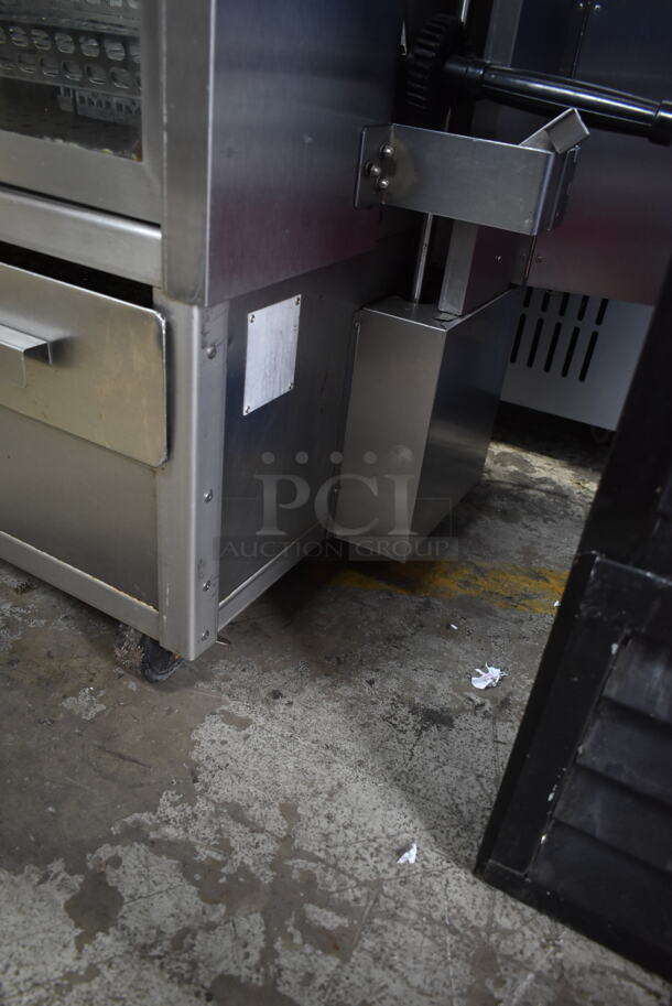 Stainless Steel Commercial Floor Style Natural Gas Powered 7 Spit Rotisserie Oven on Commercial Casters.  - Image 5 of 9