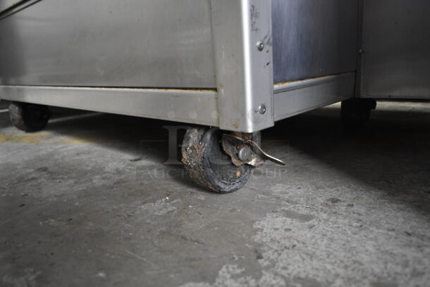 Stainless Steel Commercial Floor Style Natural Gas Powered 7 Spit Rotisserie Oven on Commercial Casters.  - Image 8 of 9