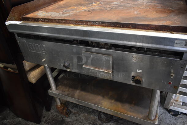 Lang Stainless Steel Commercial Natural Gas Powered Flat Top Griddle w/ Metal Under Shelf on Commercial Casters.  - Image 3 of 4