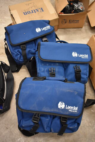 3 VitalSlim Items; 1 Arrhythmia Trainer and 2 VitalSlim Vital Signs Simulator in 3 Laerdal Blue Bags. 3 Times Your Bid! (front room)