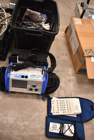 ALL ONE MONEY! Lot of Various Items Including Zoll M Series Monitor, HeartSim 200, Wires and Headphones. (front room)