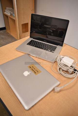 2 Apple A1286 15" MacBook Pro Laptops. 2 Times Your Bid! (front room)