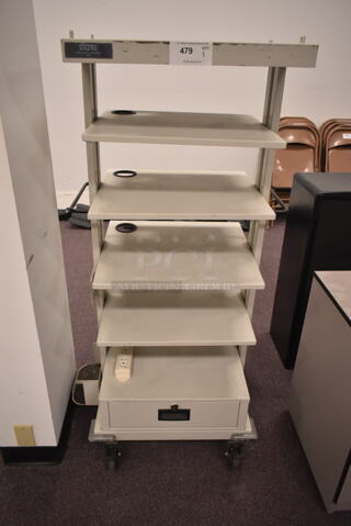 Gray Shelving Unit on Casters. (back room)