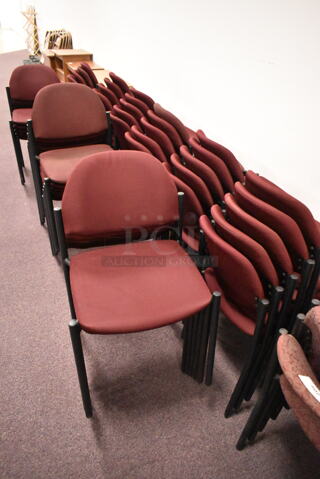 48 Stackable Maroon Chairs on Black Metal Legs. 48 Times Your Bid! BUYER MUST REMOVE: Bring Tools and Manpower Needed To Remove This Item. (back room)