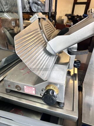 Berkel B12-SLC 12 inch Medium-Duty Gravity Feed Manual Meat Slicer - 1/2 hp Working
