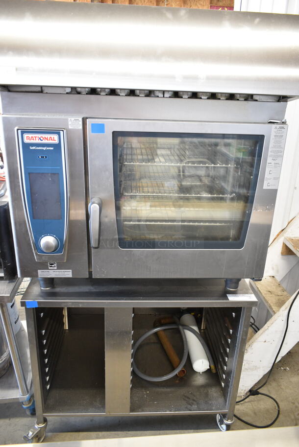 2019 Rational SCC WE 62 Stainless Steel Commercial Electric Powered SelfCooking Center Combi Convection Oven w/ Hood on Equipment Stand. 208 Volts, 3 Phase. Unit Was Pulled From a Working Environment! - Image 1 of 10