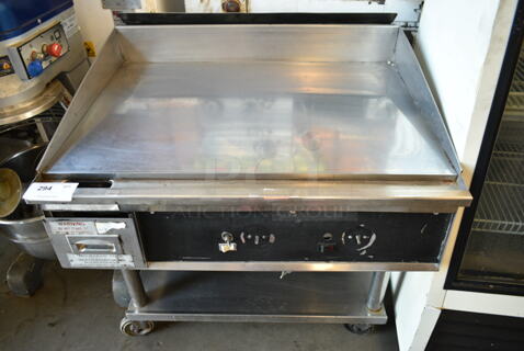 Stainless Steel Commercial Gas Powered Chrome Top Flat Top Griddle w/ Under Shelf on Commercial Casters. 