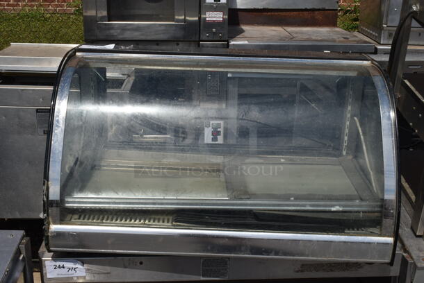 Metal Commercial Countertop Display Case Merchandiser. See Pictures for Cracked Glass. Tested and Powers On But Parts Do Not Move - Image 1 of 3