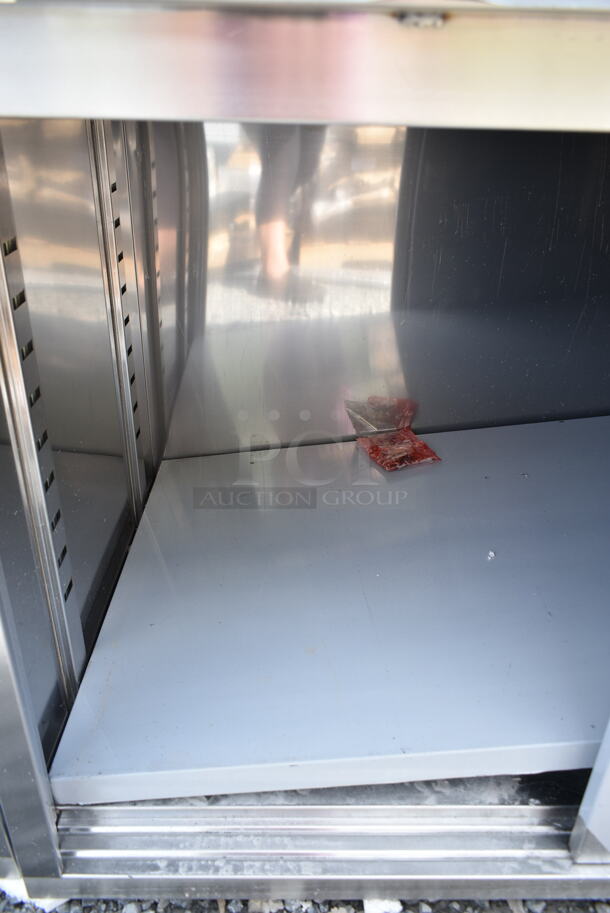 BRAND NEW SCRATCH AND DENT! Regency 600EBTB3060R 30" x 60" 16 Gauge Type 304 Stainless Steel Enclosed Base Sliding Door Table with Drawers and 6" Backsplash - Image 3 of 6