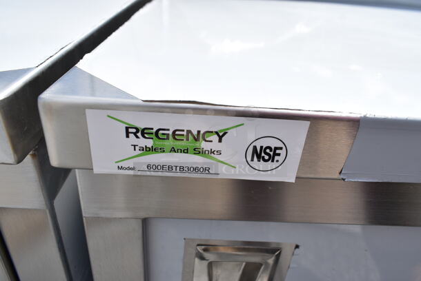 BRAND NEW SCRATCH AND DENT! Regency 600EBTB3060R 30" x 60" 16 Gauge Type 304 Stainless Steel Enclosed Base Sliding Door Table with Drawers and 6" Backsplash - Image 6 of 6