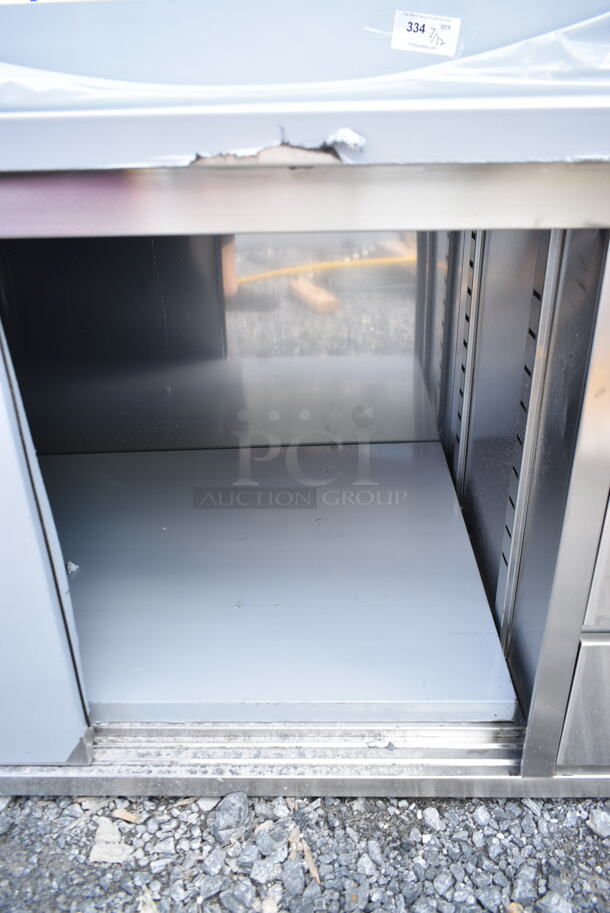 BRAND NEW SCRATCH AND DENT! Regency 600EBTB3060R 30" x 60" 16 Gauge Type 304 Stainless Steel Enclosed Base Sliding Door Table with Drawers and 6" Backsplash - Image 5 of 7