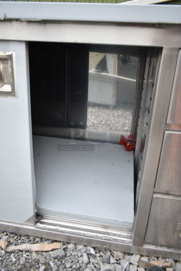 BRAND NEW SCRATCH AND DENT! Regency 600EBT2460R 24" x 60" 16 Gauge Type 304 Stainless Steel Enclosed Base Sliding Door Table with Drawers - Image 3 of 6