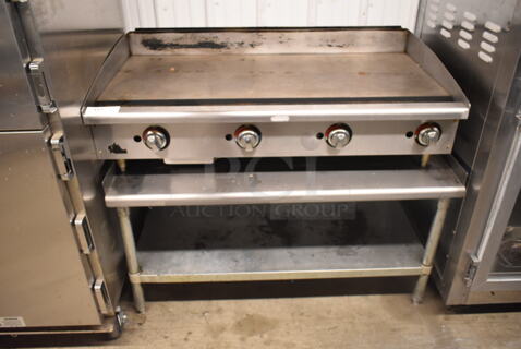 Star Stainless Steel Commercial Countertop Natural Gas Powered Flat Top Griddle on Stainless Steel Equipment Stand. 