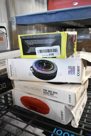 4 BRAND NEW IN BOX! Items Including Waterproof True Wireless Speaker, Wall Mount For Echo Dot, Coby Bluetooth Speaker. 4 Times Your Bid! 