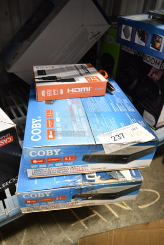3 BRAND NEW IN BOX! Items Including 2 Coby Compact 5.1 Channel DVD Player, Coby HDMI High Speed Cable. 3 Times Your Bid!