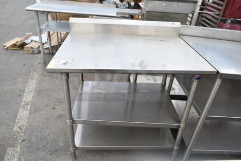Stainless Steel Table w/ 2 Under Shelves and Back Splash. 