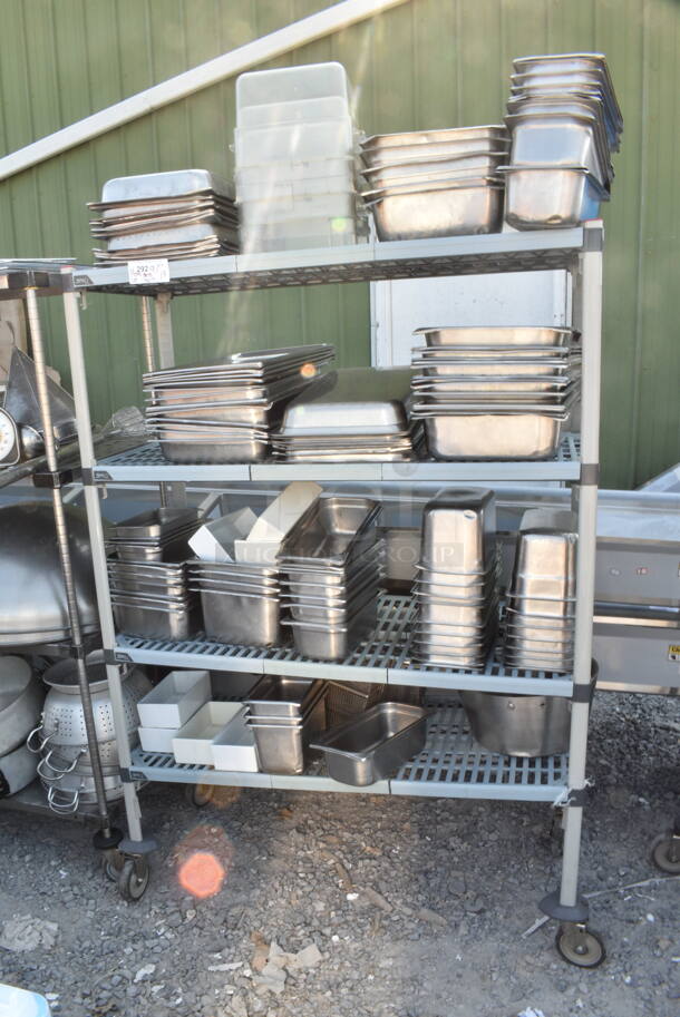 Metal and Poly 4 Tier Wire Shelving Unit on Commercial Casters w/ Contents Including Stainless Steel Drop In Bins. BUYER MUST DISMANTLE. PCI CANNOT DISMANTLE FOR SHIPPING. PLEASE CONSIDER FREIGHT CHARGES. - Image 1 of 1