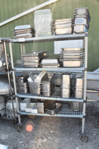 Metal and Poly 4 Tier Wire Shelving Unit on Commercial Casters w/ Contents Including Stainless Steel Drop In Bins. BUYER MUST DISMANTLE. PCI CANNOT DISMANTLE FOR SHIPPING. PLEASE CONSIDER FREIGHT CHARGES.
