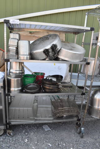 Chrome Finish 4 Tier Wire Shelving Unit on Commercial Casters w/ Contents Including Metal Stock Pots, Stainless Steel Drop In Bins, Metal Fry Baskets, Skillets. BUYER MUST DISMANTLE. PCI CANNOT DISMANTLE FOR SHIPPING. PLEASE CONSIDER FREIGHT CHARGES.