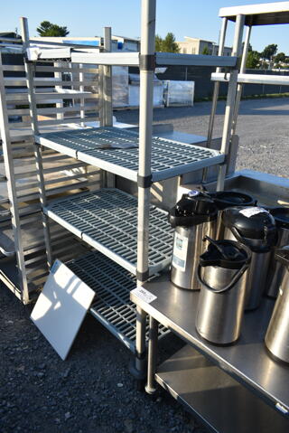 Poly and Metal 4 Tier Wire Shelving Unit on Commercial Casters. Buyer Must Pick Up - We Will Not Ship This Item.
