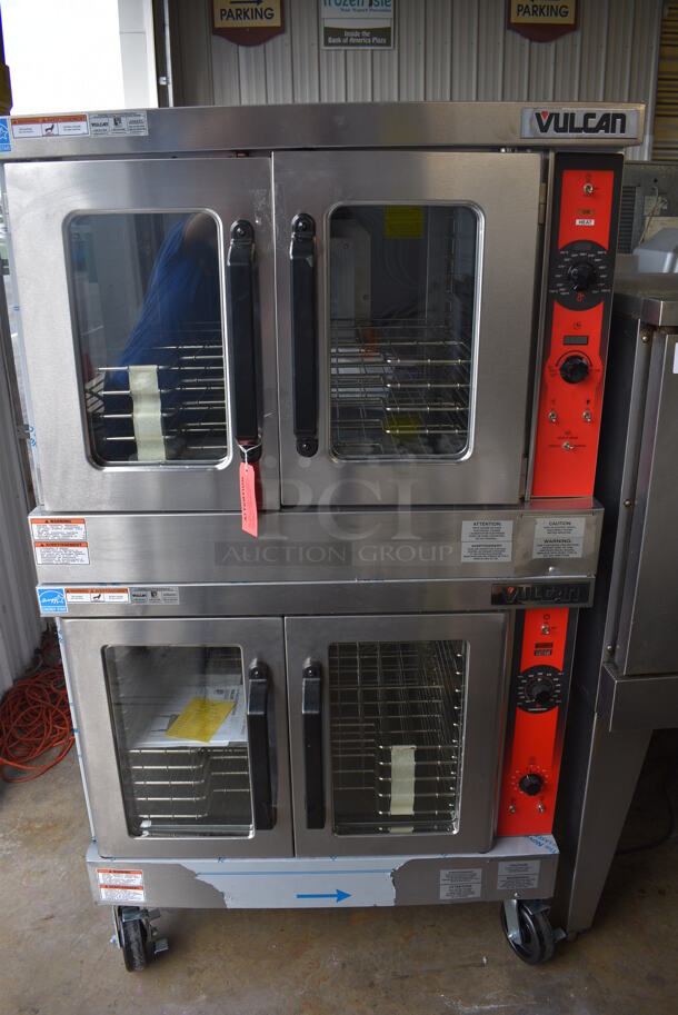 2 BRAND NEW SCRATCH AND DENT! LATE MODEL! Vulcan VC5ED Stainless Steel Commercial Electric Powered Full Size Convection Oven w/ View Through Doors, Metal Oven Racks and Thermostatic Controls on Commercial Casters. 208 Volts, 3/1 Phase. 40x31x70. 2 Times Your Bid! Tested and Working!