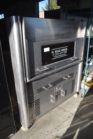 H. Ruiz 106 Stainless Steel Commercial Floor Style Wood Fired Grilled Chicken Rotisserie Oven on Commercial Casters. 59x38x66