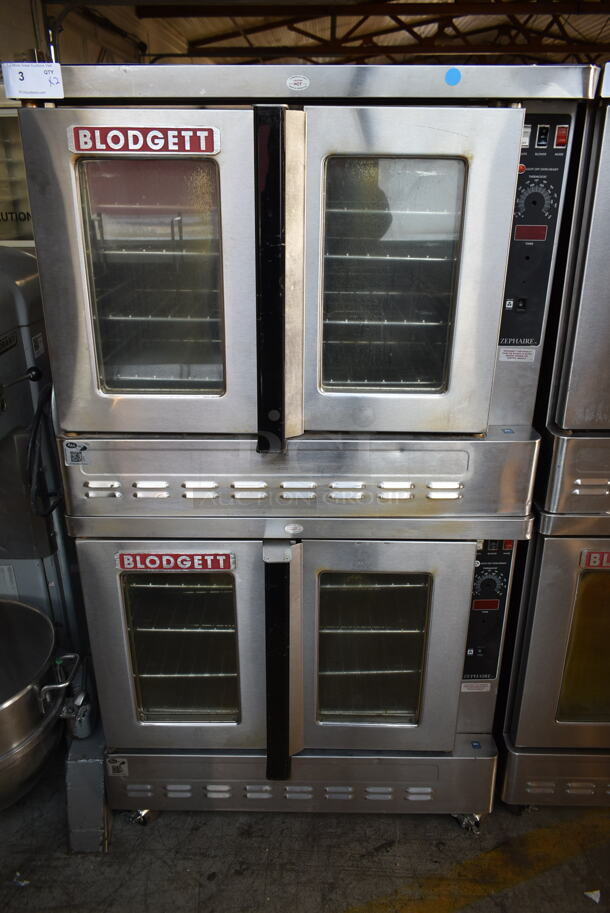 2 Blodgett Zephaire-200-G Stainless Steel Commercial Natural Gas Powered Full Size Convection Ovens w/ View Through Doors, Metal Oven Racks and Thermostatic Controls on Commercial Casters. 60,000 BTU. 2 Times Your Bid!