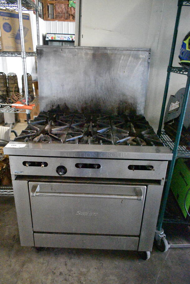 Garland SunFire Stainless Steel Commercial Natural Gas Powered 6 Burner Range w/ Oven, Back Splash and Contents on Commercial Casters.  - Image 1 of 7