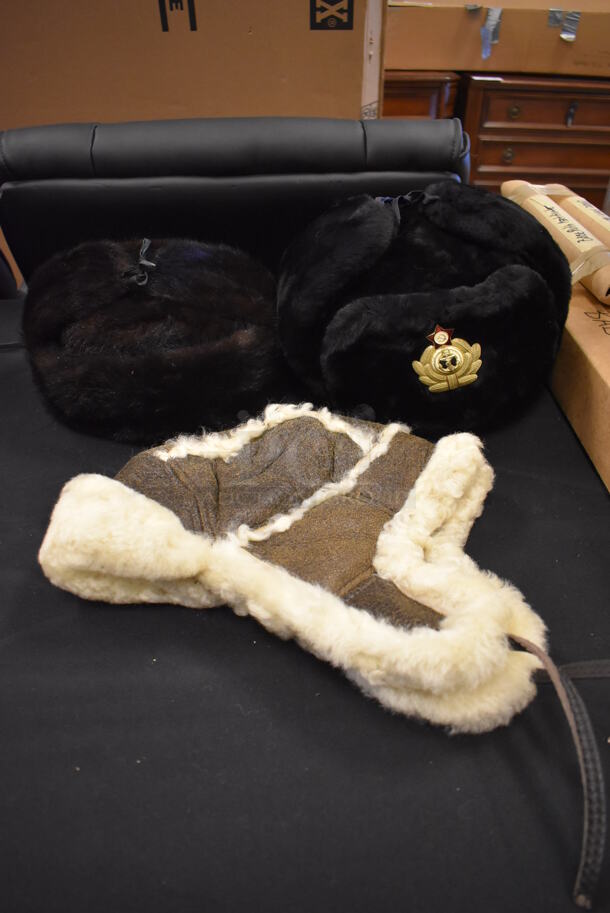 3 Various Fur Hats; Ushanka Hat, Ushanka Hat w/ Soviet Navy Insignia and Leather Fur Lined Bomber Hat. 3 Times Your Bid!
