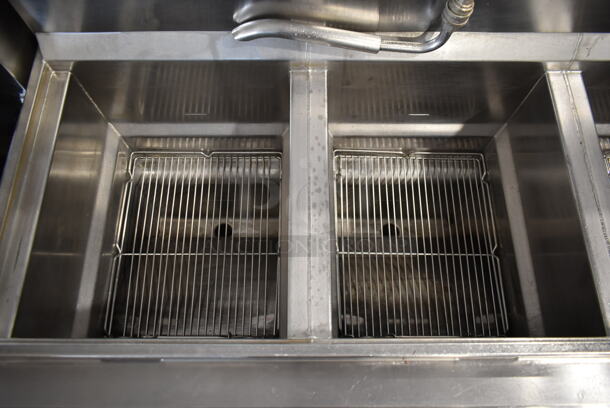 Henny Penny CG-303 Stainless Steel Commercial Floor Style  Natural Gas Powered 3 Bay Deep Fat Fryer w/ 3 Lids and 4 Metal Fry Baskets on Commercial Casters. 240,000 BTU. - Image 7 of 10