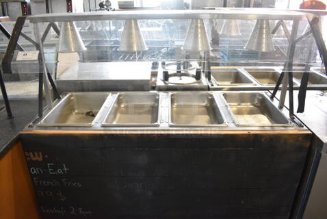 Vollrath Model 3871060 Stainless Steel Commercial 4 Well Steam Table w/ 4 Lamps and Sneeze Guard. 120 Volts, 1 Phase. 60x29x58. Cannot Test Due To Plug Style