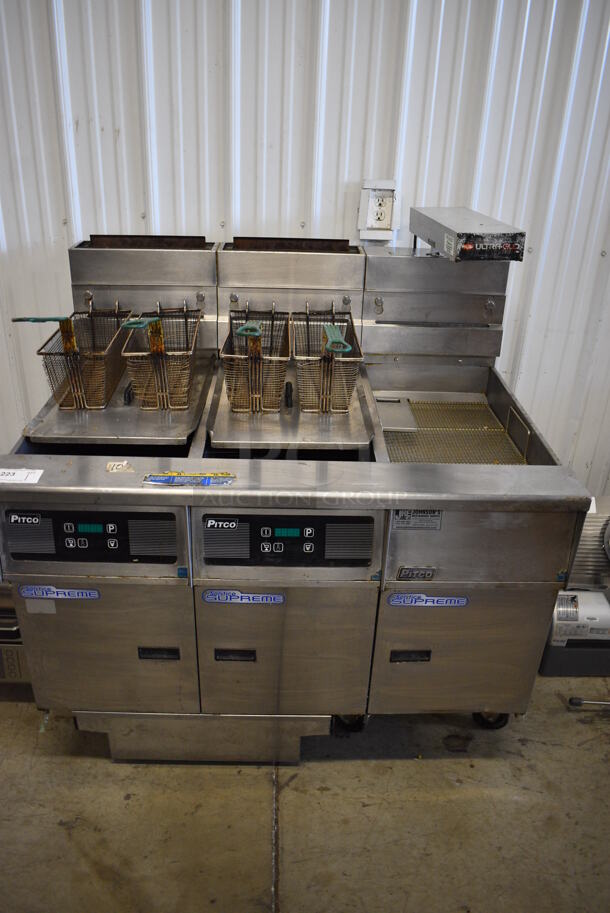 2013 Pitco Frialator SSH55 Stainless Steel Commercial Floor Style Natural Gas Powered 2 Bay Deep Fat Fryer w/ Right Side SSHBNB55 Dumping Station, 4 Metal Fry Baskets, 2 Metal Lids on Commercial Casters. 80,000 BTU. 47x35x47