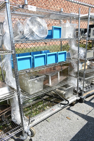 Chrome Finish 5 Tier Shelving Unit w/ Contents Including Blue Silverware Caddies, China Cap Strainers. BUYER MUST DISMANTLE. PCI CANNOT DISMANTLE FOR SHIPPING. PLEASE CONSIDER FREIGHT CHARGES. 