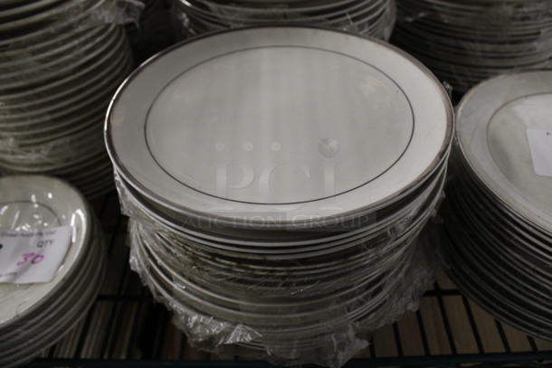 17 White Ceramic Plates w/ Silver Colored Lines on Rim. 8x8x1. 17 Times Your Bid!